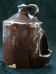 Chicken waterer, stoneware, Albany slip glaze, one-piece, molded, hand-formed, with handle, with hood.  Mark:  'Dalton Pottery, Dalton, O'.